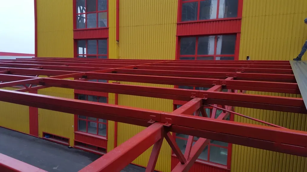 Detail of a red steel structure on a building facade